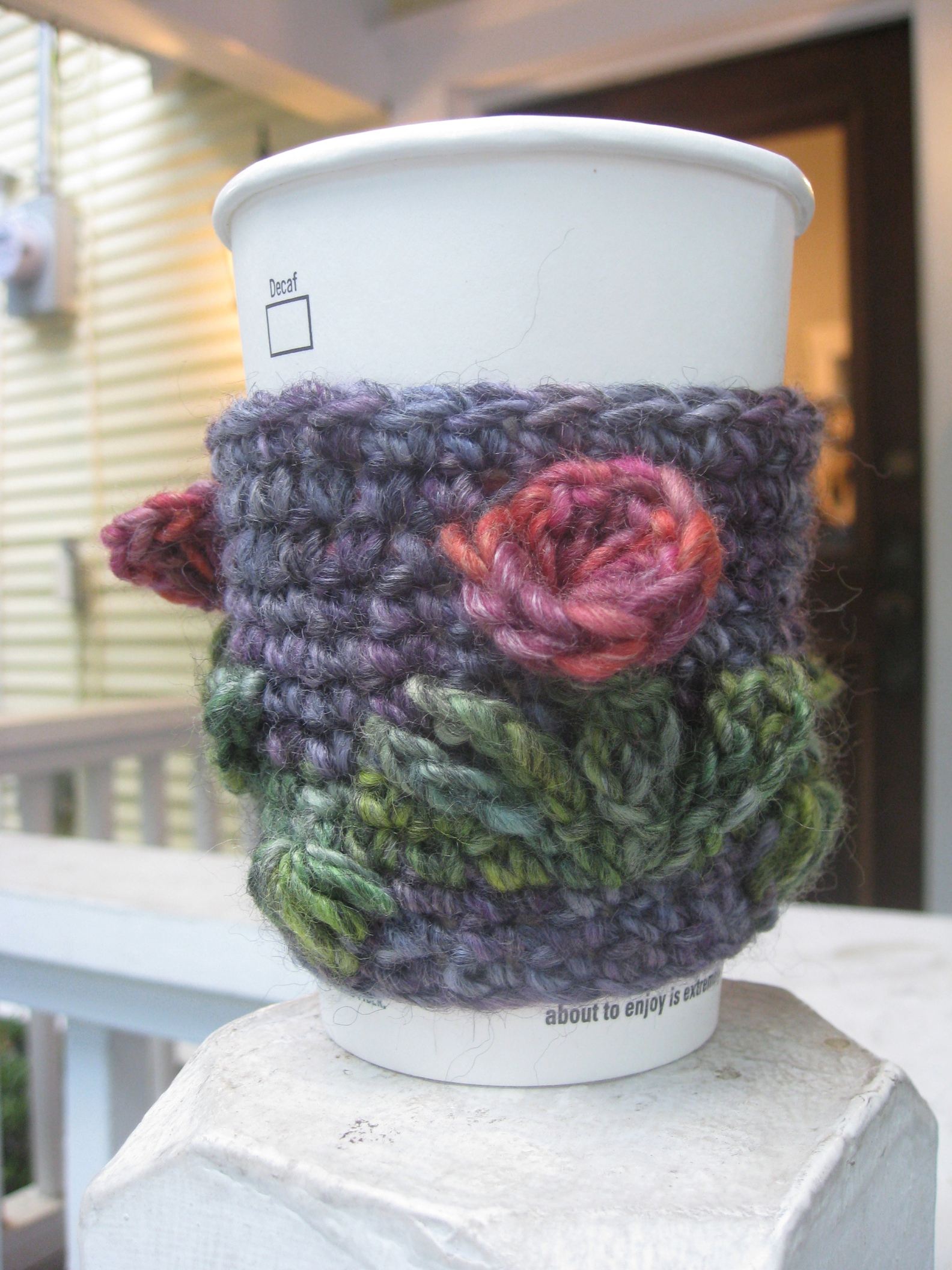 crochet coffee cozy around a paper coffee cup