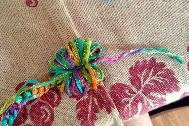 Tie yarn across yarn loops