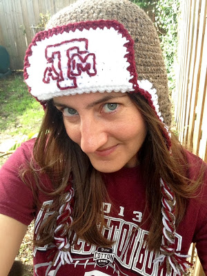 Me wearing an ear flap hat with the Texas A&M logo embroidered on the front