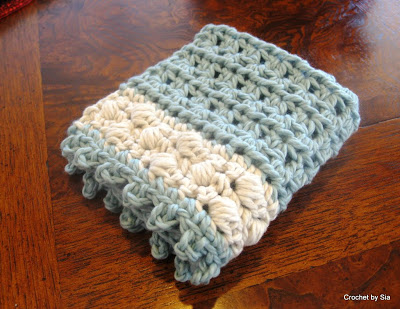 Folded Crochet potholder sitting on a table